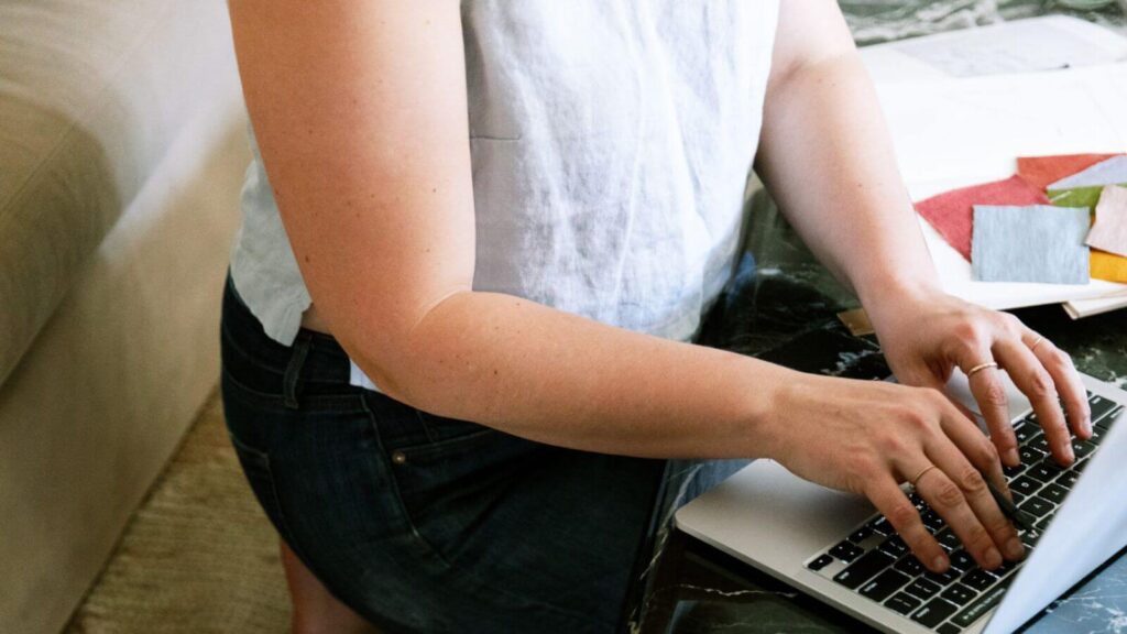 Woman on laptop setting up 5 automations for an online service business